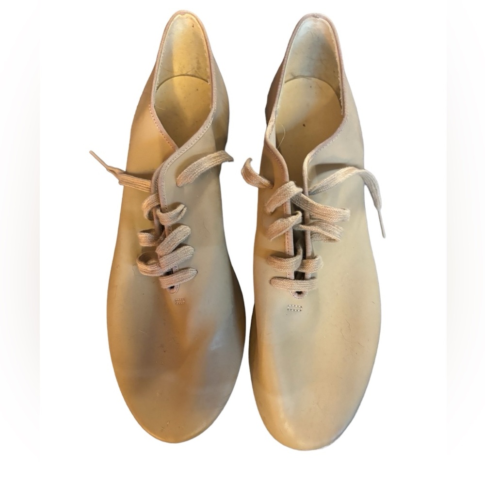 Fawn colored leather dance shoes. Leather upper and bottoms.